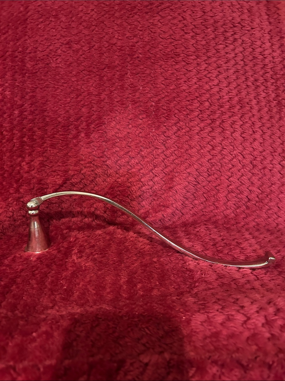 Candle snuffer with hinged bell shaped head
